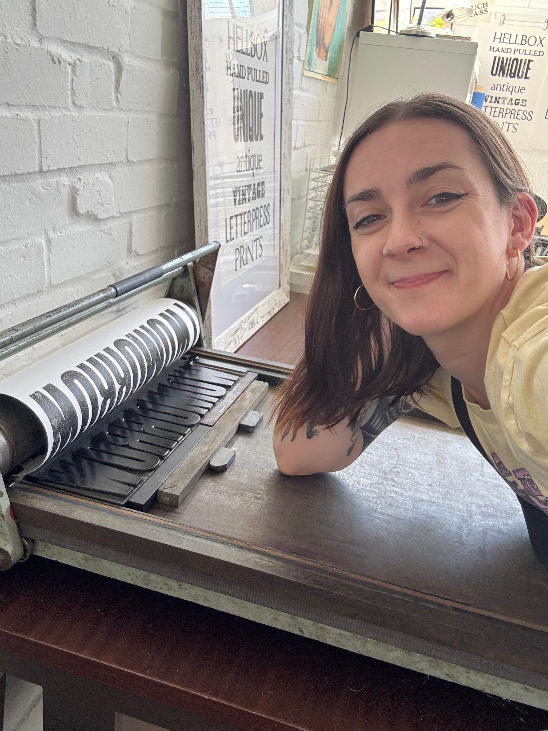 Ruby Rose Ellis | Leaning on her Farley Proofing Press, Letterpress Artist in Leighton Buzzard